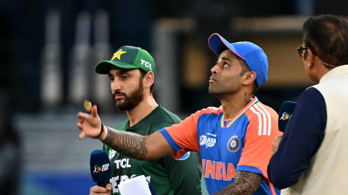 India's captain Suryakumar Yadav (C) tosses the coin at the start of the Asia Cup 2025 Twenty20 international cricket match between India and Pakistan at the Dubai International Stadium in Dubai on September 14, 2025