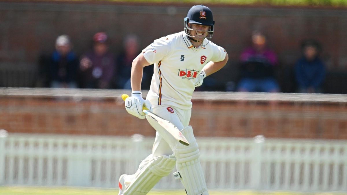 Jordan Cox holds his side after running a single for Essex in the County Championship