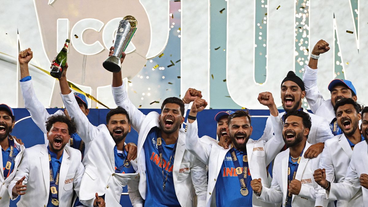 India's players celebrate with the trophy after winning the ICC Champions Trophy one-day international (ODI) final cricket match between India and New Zealand at the Dubai International Stadium in Dubai on March 9, 2025