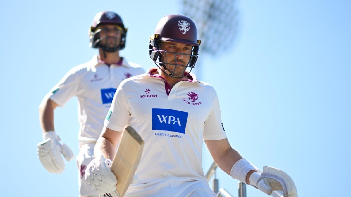 Josh Davey walks out to open the batting for Somerset