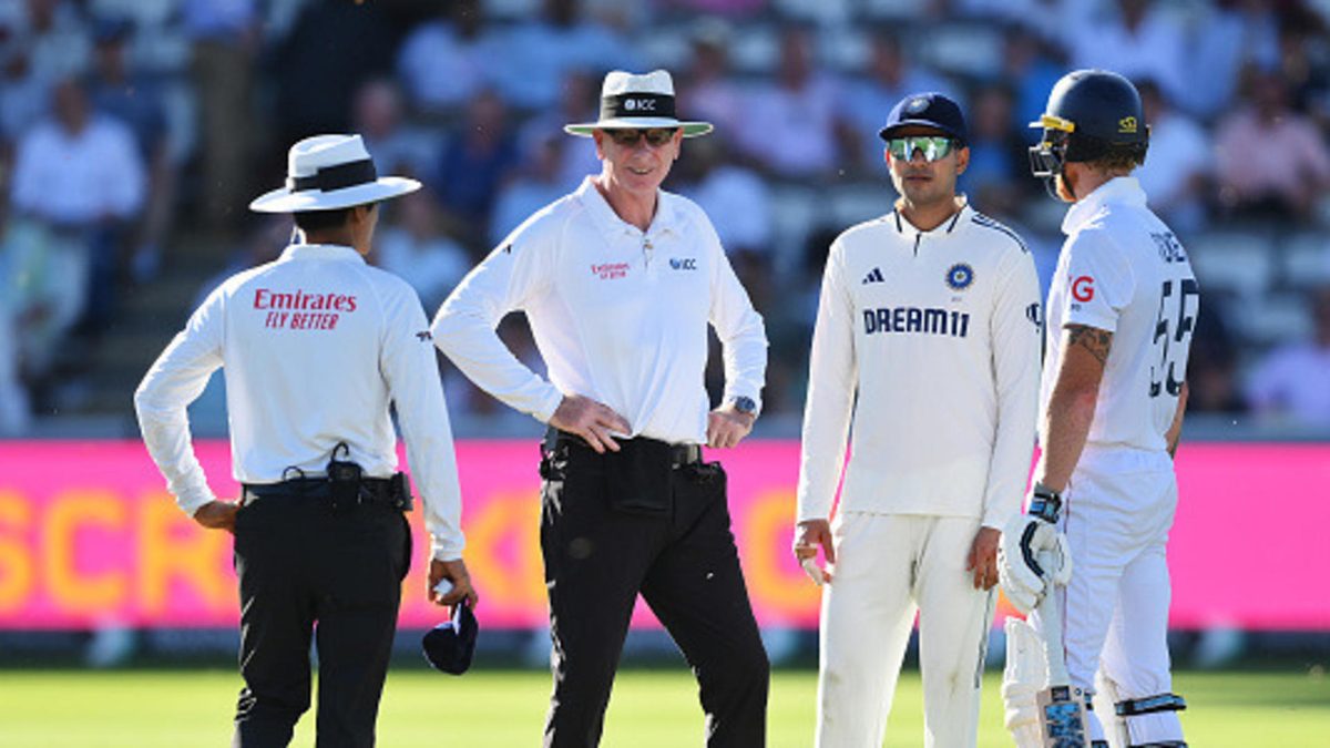 Ben Stokes of England and Shubman Gill of India talk with Umpires Paul Reiffel and Sharfuddoula as the pitch is covered by flying ants and ladybirds during Day One of the 3rd Rothesay Test Match between England and India at Lord's Cricket Ground on July 10, 2025 in London, England