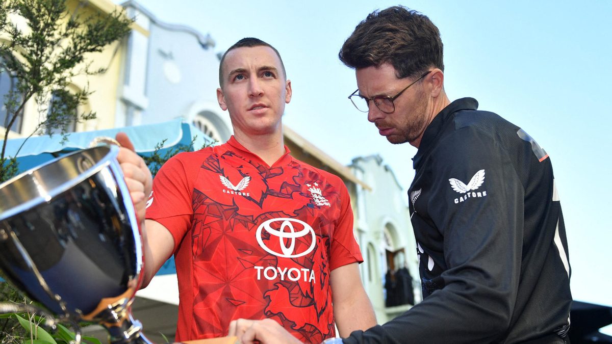 Cricket captains New Zealand's Mitchell Santner (R) and England's Harry Brook inspect the T20 international cricket series trophy between New Zealand and England during a media opportunity in Christchurch on October 15, 2025