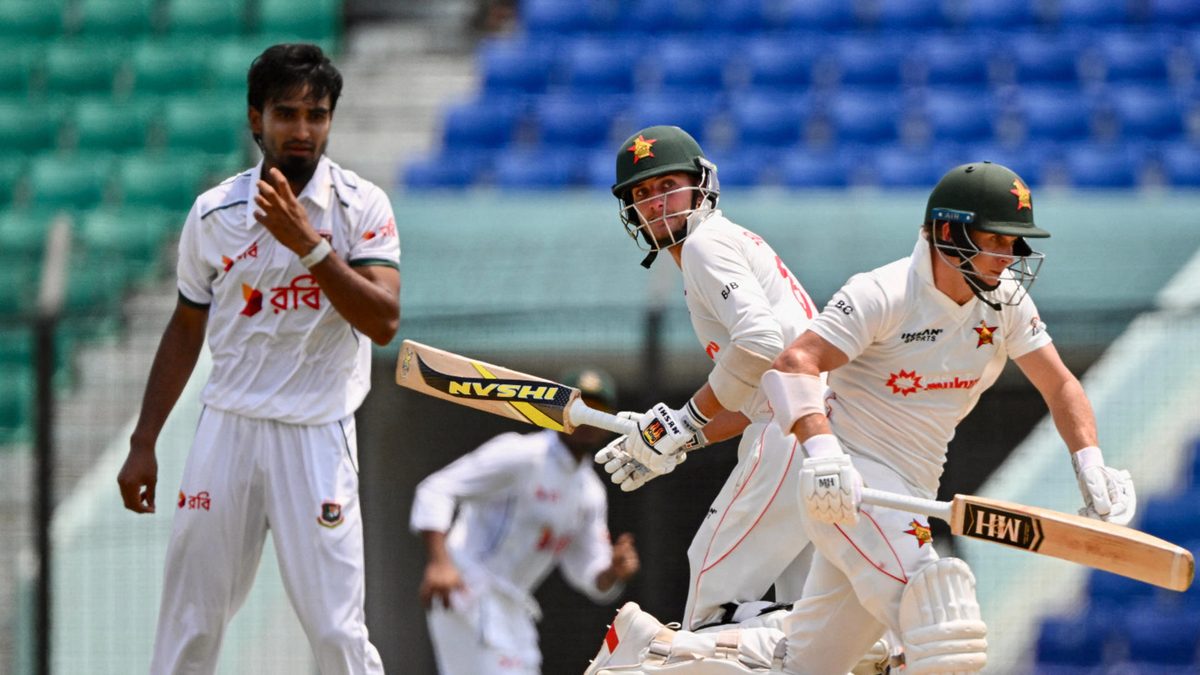 Zimbabwe's Brian Bennett (C) and Ben Curran (r) run between the wickets as Bangladesh's Tanzim Hasan Sakib (L) watches during the first day of the second Test cricket match between Bangladesh and Zimbabwe at a cricket stadium in Chittagong on April 28, 2025