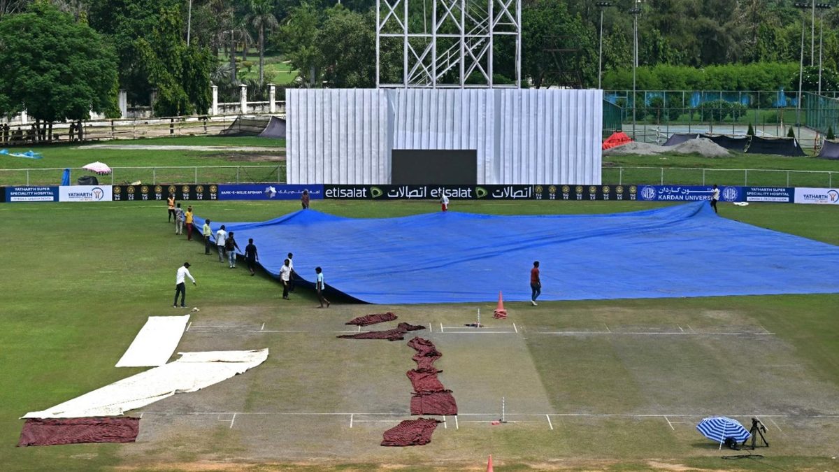 Officials attempt to dry the Greater Noida pitch for Afghanistan v New Zealand Test match