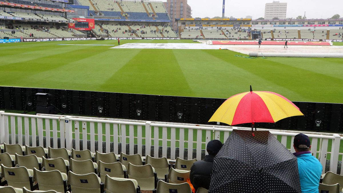 Spectators wait for the rain to stop, and play to start, on day five of the first Ashes cricket Test match between England and Australia at Edgbaston in Birmingham, central England on June 20, 2023