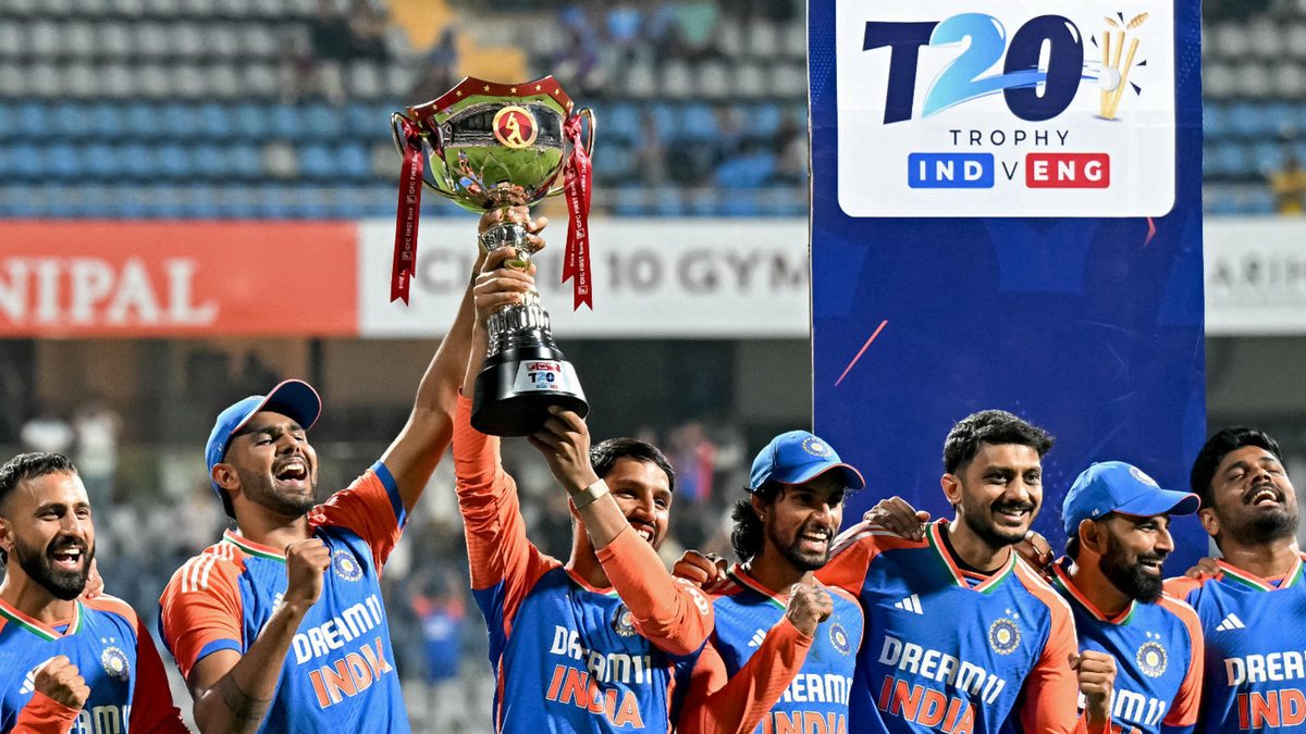 India's players pose with the trophy as they celebrate after their team's win at the end of the fifth and final Twenty20 international cricket match between India and England at the Wankhede Stadium in Mumbai on February 2, 2025