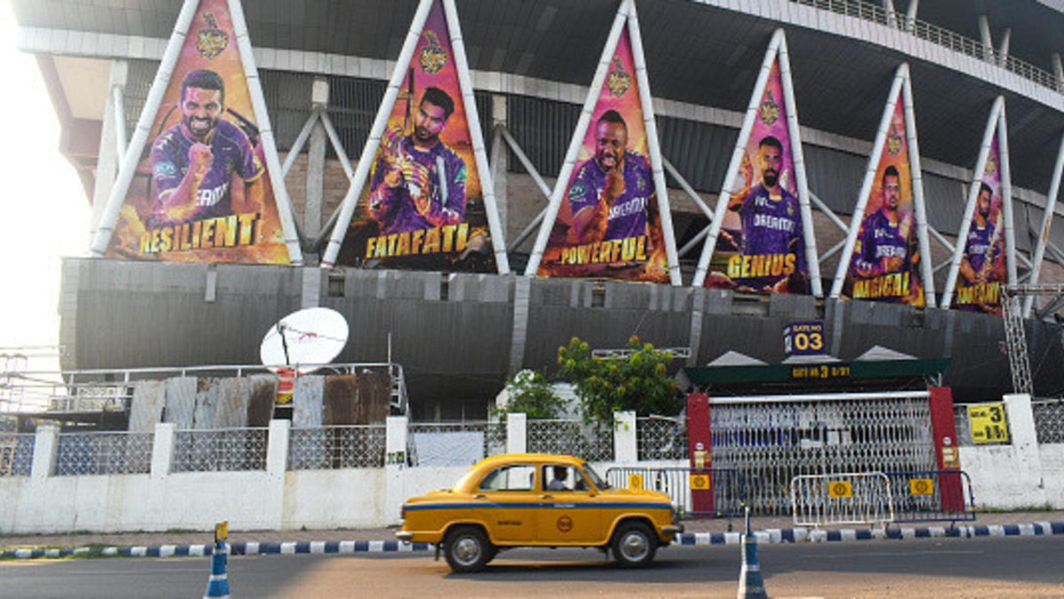 A yellow taxi passes next to the Eden Garden stadium in Kolkata, India, on May 11, 2025