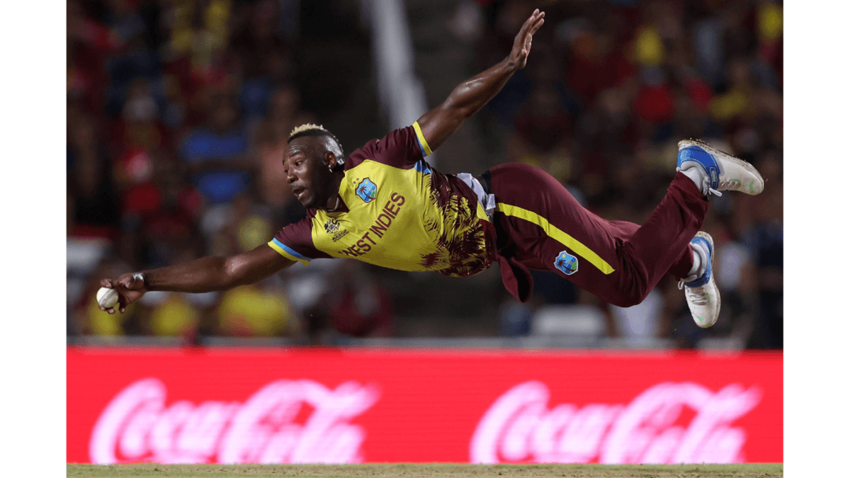 West Indies' Andre Russell athletically fields off his own bowling.