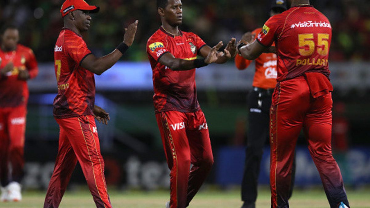 Akeal Hosein (C) of Trinbago Knight Riders celebrates with teammates Kieron Pollard (R) and Dwayne Bravo (L) after dismissing Keemo Paul of Guyana Amazon Warriors during the Republic Bank Caribbean Premier League Final between Trinbago Knight Riders and Guyana Amazon Warriors at Providence Stadium on September 24, 2023 in Georgetown, Guyana.