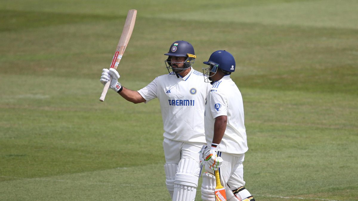 Karun Nair of India A (L) is congratulated by Sarfaraz Khan as he acknowledges the crowd after reaching his half century during the four day match between England Lions and India A at The Spitfire Ground on May 30, 2025 in Canterbury, England
