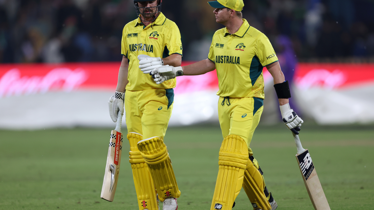 Travis Head and Steve Smith of Australia leave the field as rain stops play 