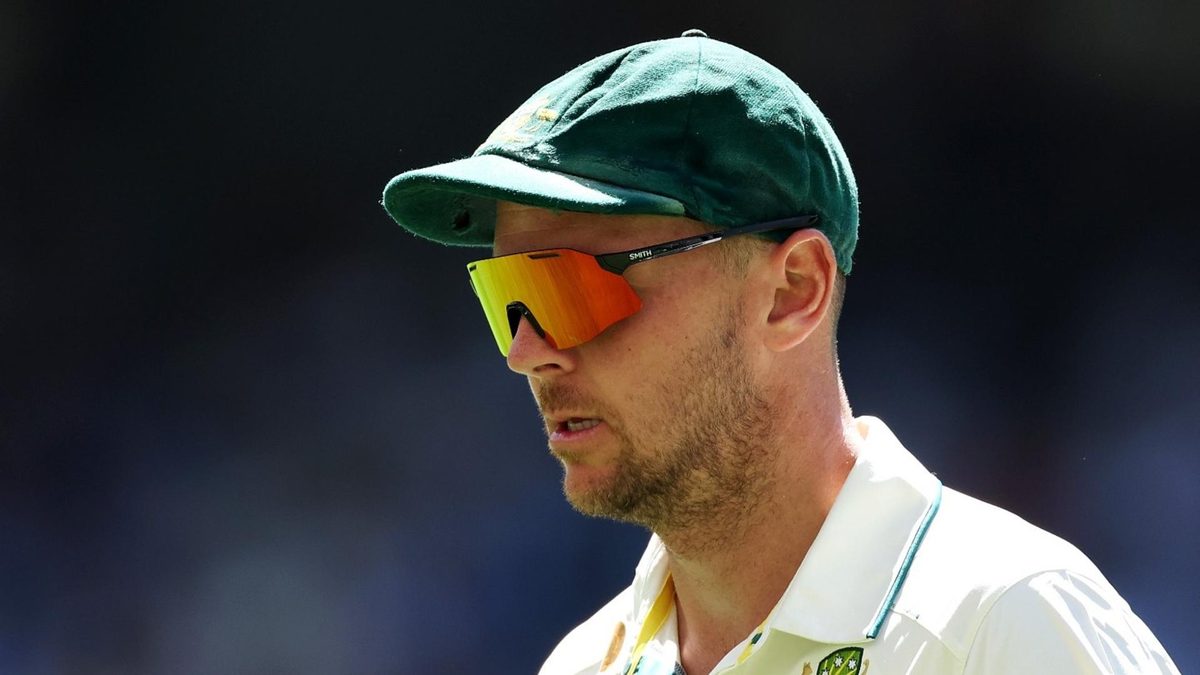 Josh Hazlewood, wearing a cap, in the field during the Australia-India Border-Gavaskar Trophy series Test at Perth
