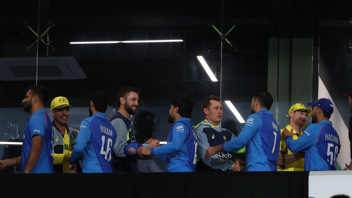 Australia and Afghanistan players shake hands after play is abandoned