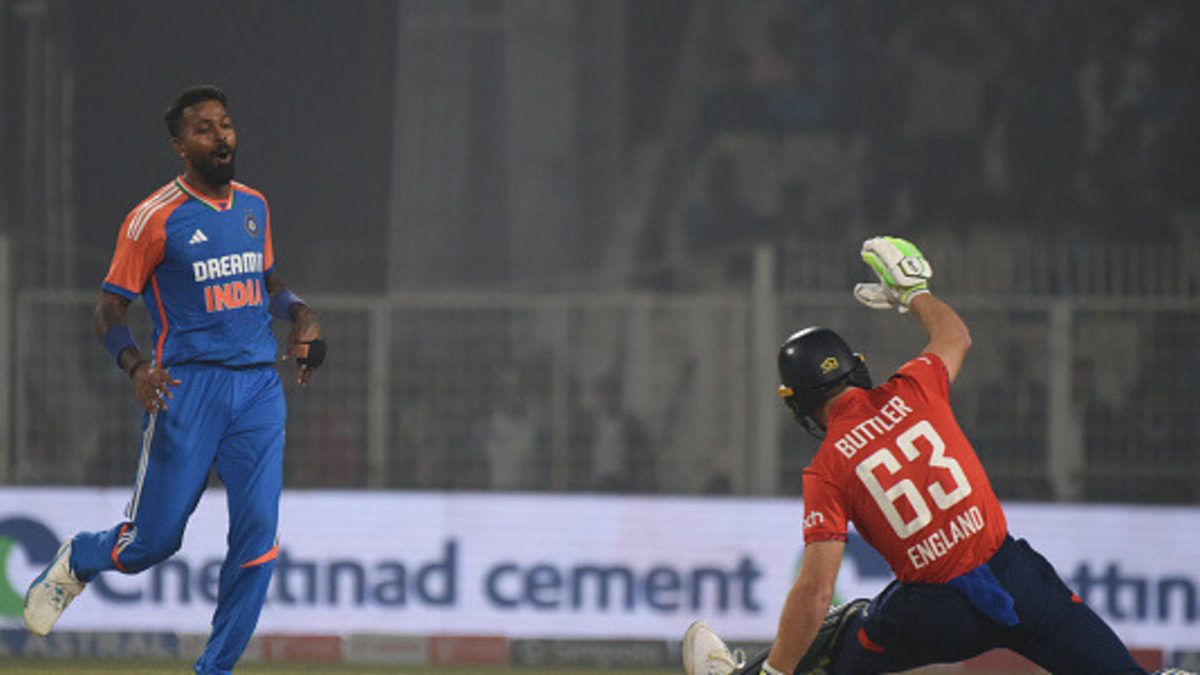 England's captain Jos Buttler falls on the ground in an attempt to play a shot on a delivery by India's Hardik Pandya, left, during the first T20 cricket match between India and England at Eden Gardens in Kolkata, India, on January 22, 2025