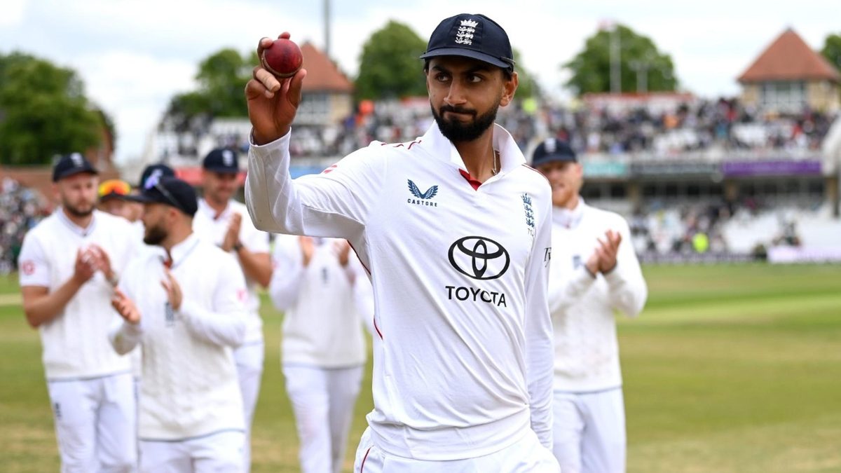 Shoaib Bashir holds the ball aloft leaving the field against Zimbabwe