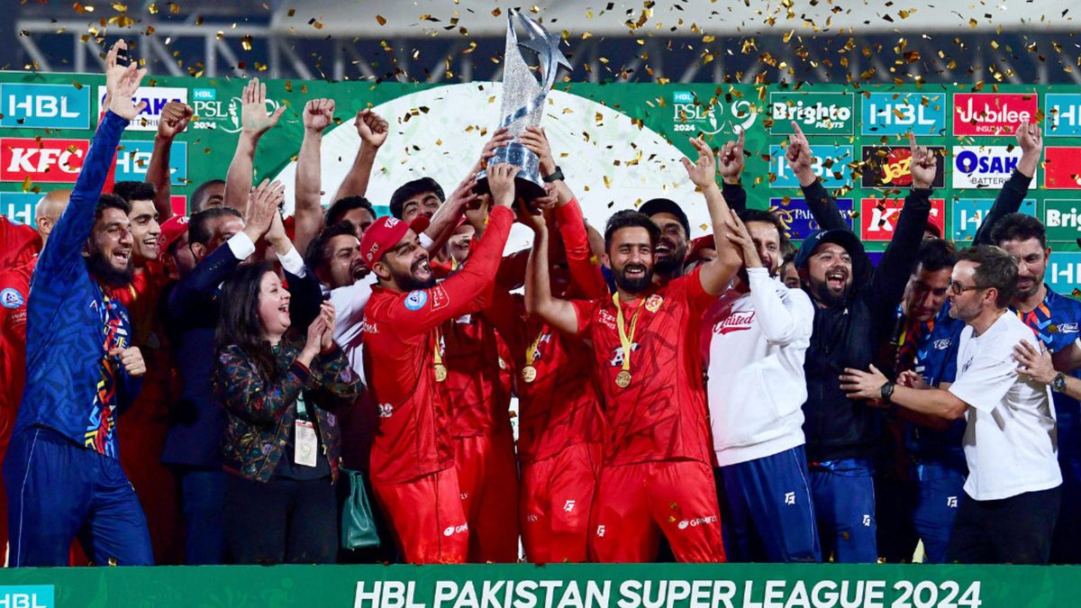 Islamabad United's players hold the Pakistan Super League (PSL) trophy as they celebrate their victory against Multan Sultans during the award ceremony for PSL Twenty20 cricket final match at the National Stadium in Karachi on March 19, 2024