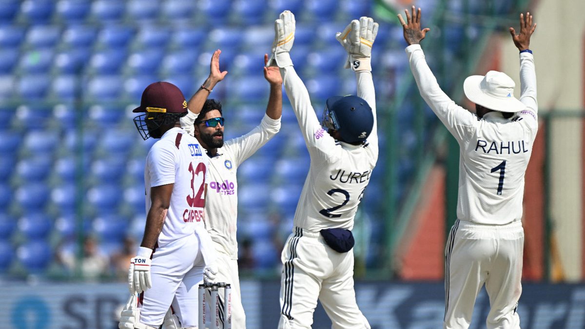 India's Ravindra Jadeja (2L) celebrates with teammates after taking the wicket of West Indies' John Campbell (L) during the fourth day of the second and last Test cricket match between India and West Indies at the Arun Jaitley Stadium in New Delhi on October 13, 2025
