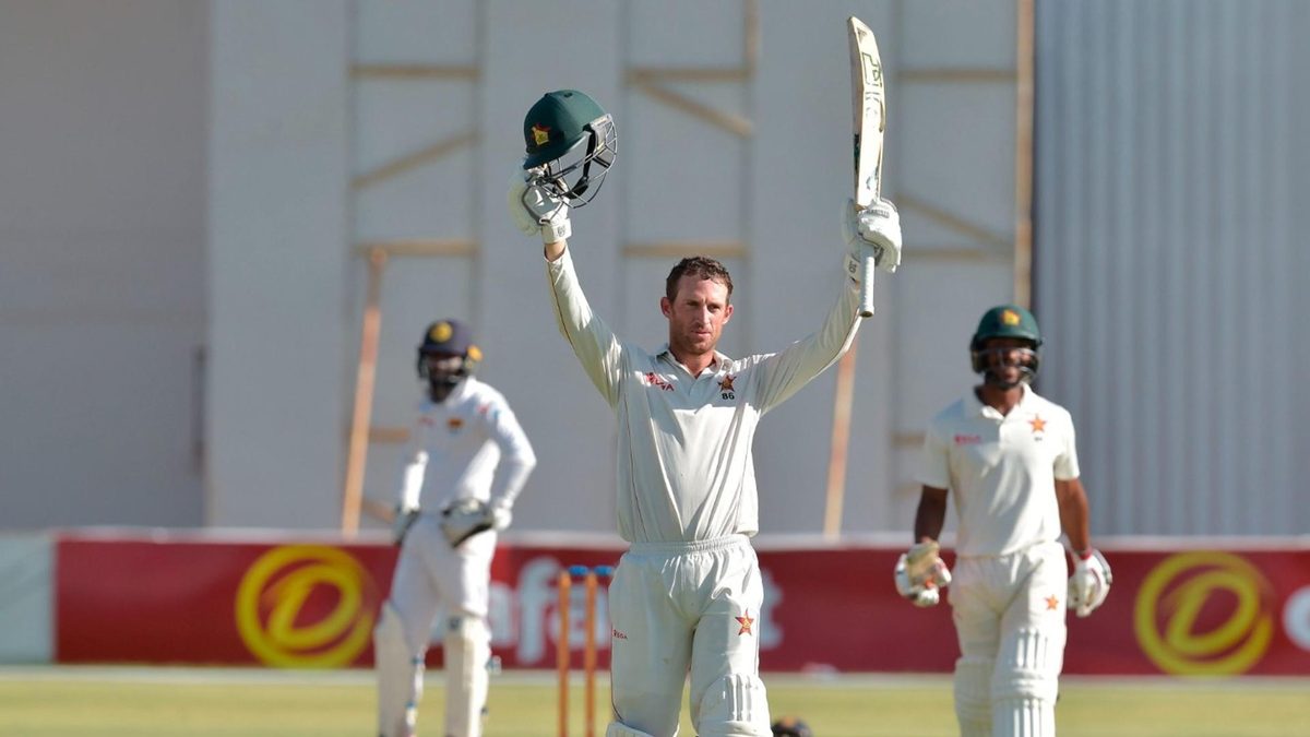 Zimbabwe batter Sean Williams raises his bat upon reaching three figures