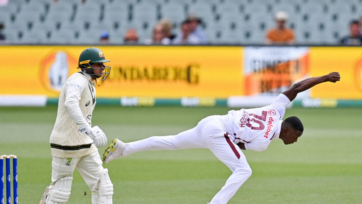 West Indies' Shamar Joseph (R) bowls during the day two of the first cricket Test match between Australia and the West Indies at the Adelaide Oval in Adelaide on January 18, 2024