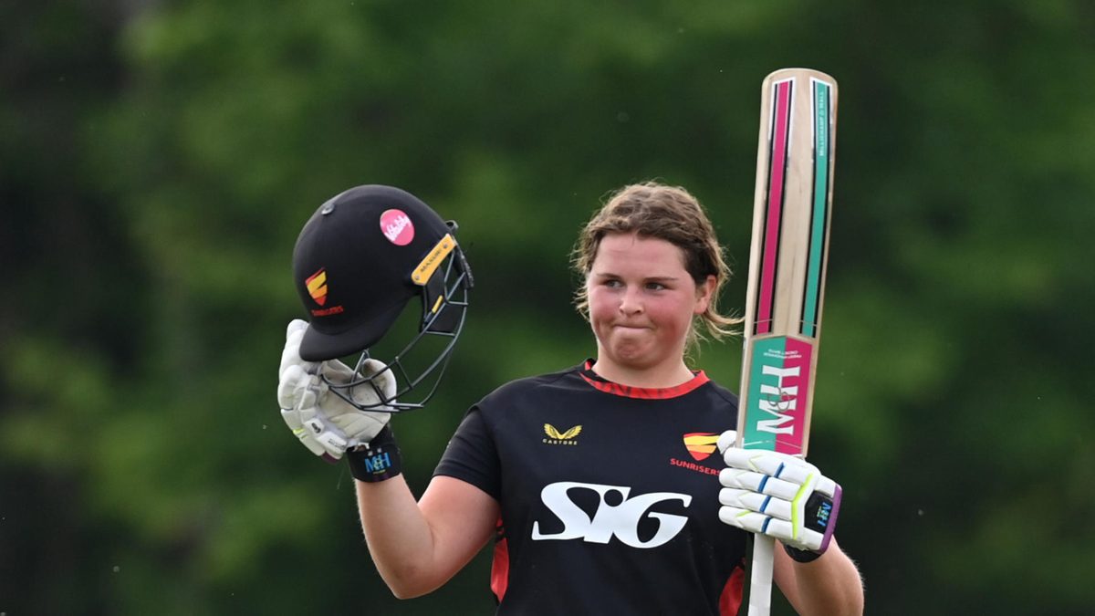 Grace Scrivens of Sunrisers celebrates reaching her century during the Rachael Heyhoe Flint Trophy match between Central Sparks and Sunrisers at Chester Road North Ground on May 01, 2024 in Kidderminster, England