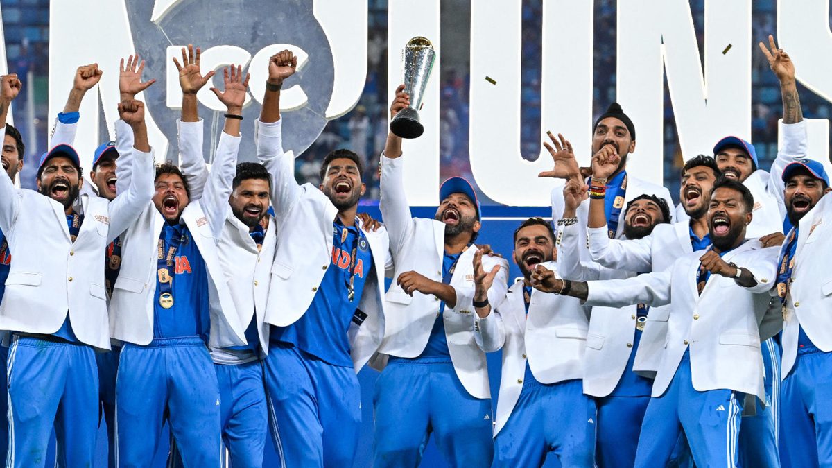 India's players celebrate with the trophy after winning the ICC Champions Trophy one-day international (ODI) final cricket match against New Zealand at the Dubai International Stadium in Dubai on March 9, 2025