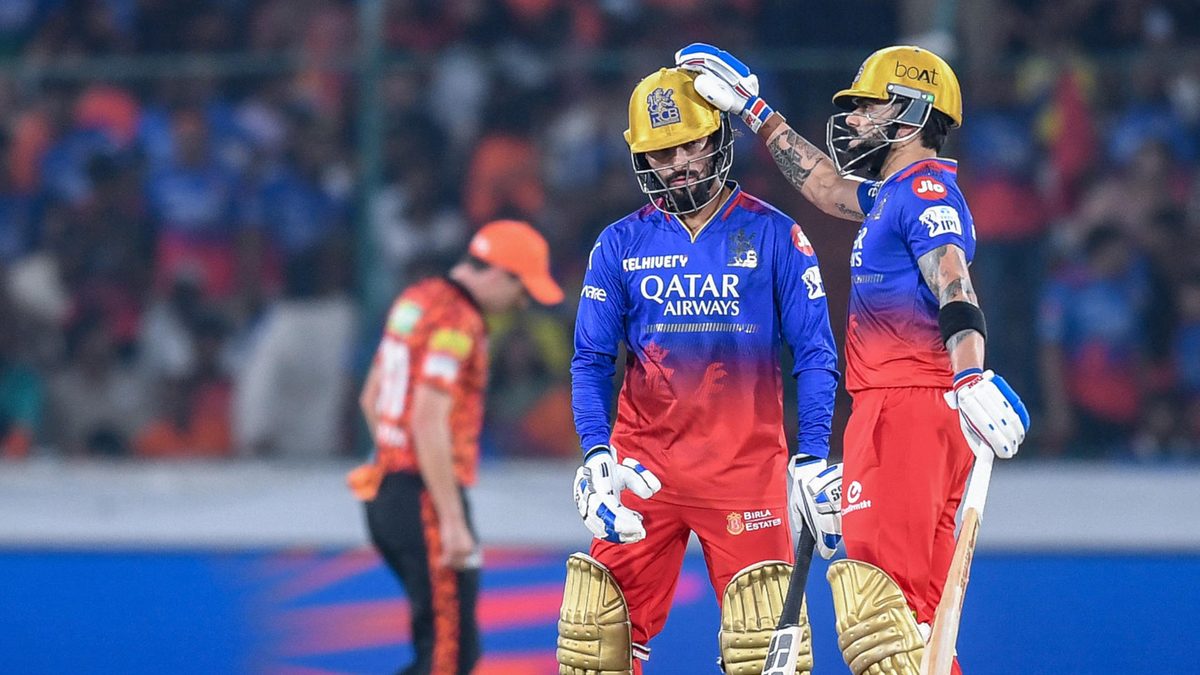 Royal Challengers Bengaluru's Rajat Patidar celebrates with his teammate Virat Kohli (R) after scoring a half-century (50 runs) during the Indian Premier League (IPL) Twenty20 cricket match between Sunrisers Hyderabad and Royal Challengers Bengaluru at the Rajiv Gandhi International Stadium in Hyderabad on April 25, 2024