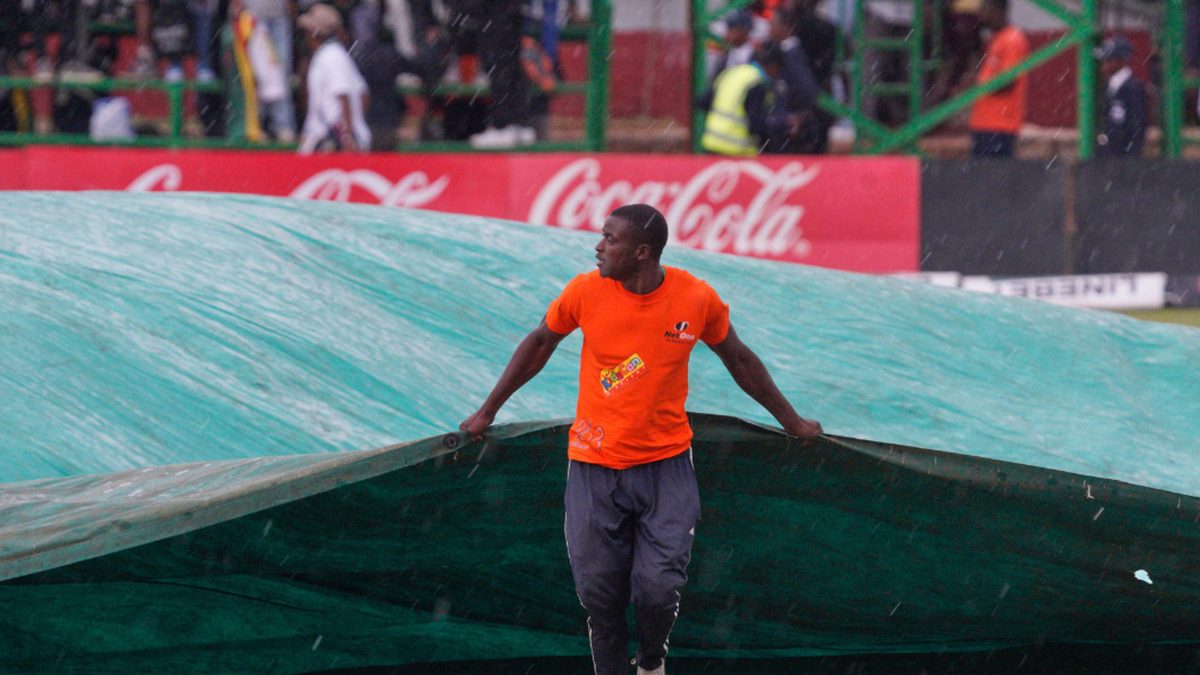 A groundsman pulls a cover to protect the wicket from the rain during the 1st ODI between Zimbabwe and Pakistan at Queens Sports Club in Bulawayo, on November 24, 2024