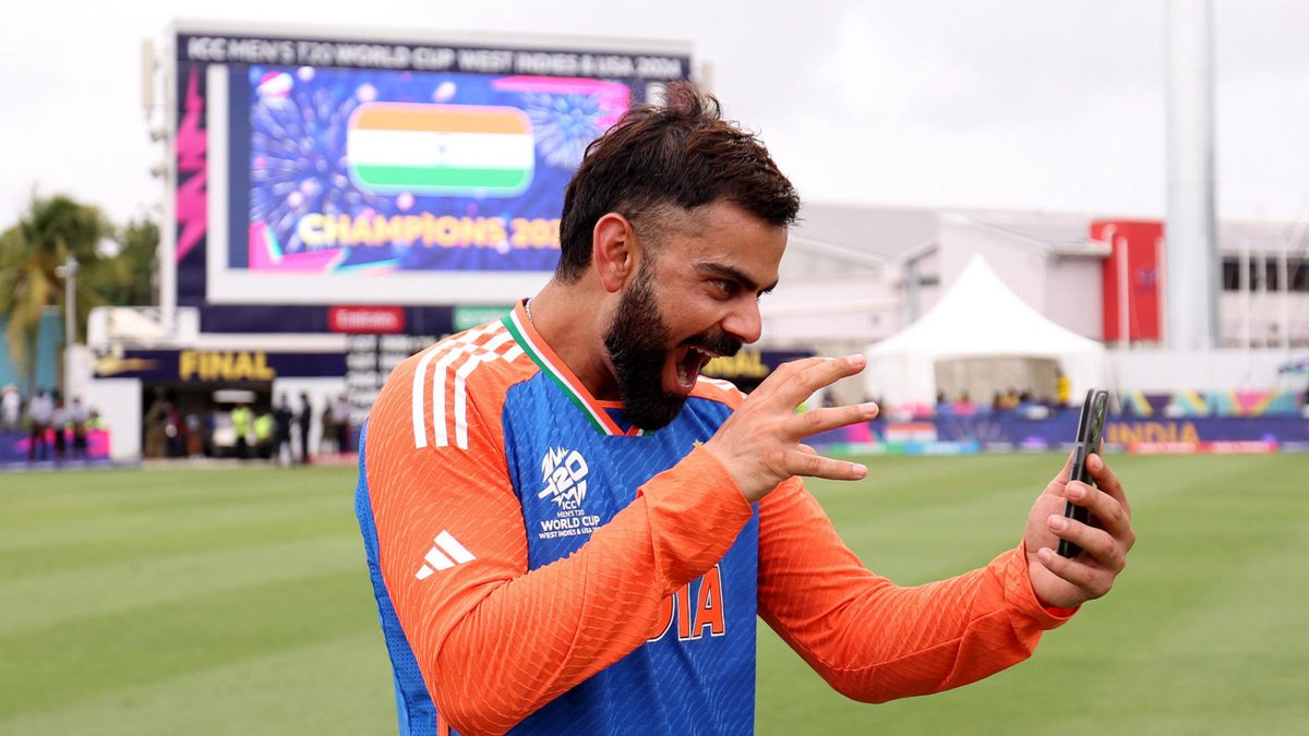 Virat Kohli of India interacts with his phone following victory after the ICC Men's T20 Cricket World Cup West Indies & USA 2024 Final match between South Africa and India at Kensington Oval on June 29, 2024 in Bridgetown, Barbados
