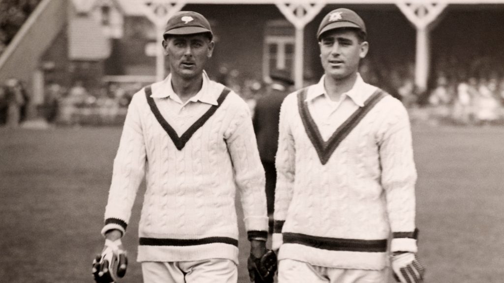 Hedley Verity (L) and Bill Voce walk out to bat during the Scarborough Cricket Festival, circa 1936