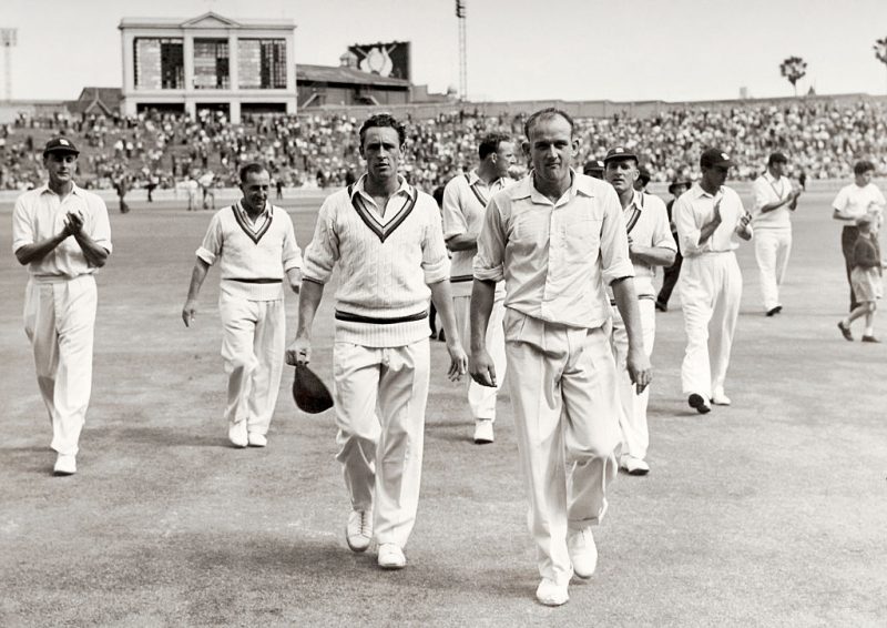 England's Frank Tyson (right) leading his team off the field after sealing a 38-run win over Australia in the Sydney Test in 1954